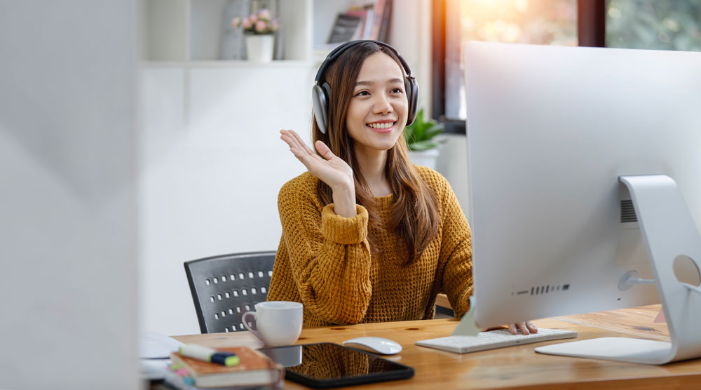 girl smiling while videoconferencing