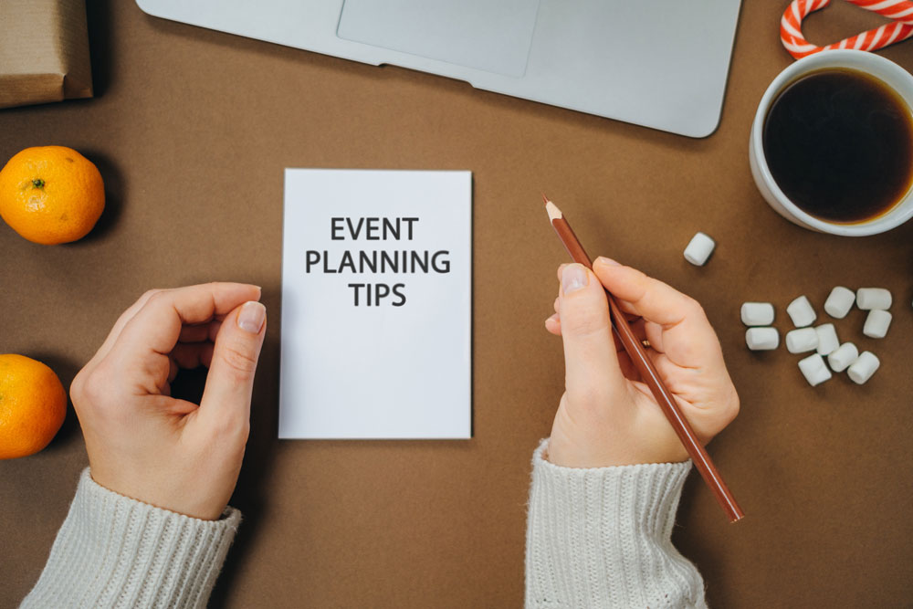 woman looking at paper with event planning tips written on it